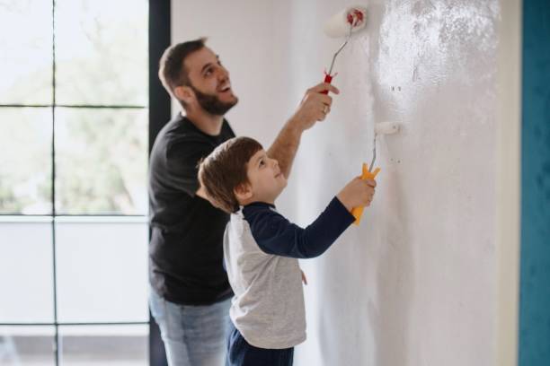 istock Father and son painting the walls 1285953092