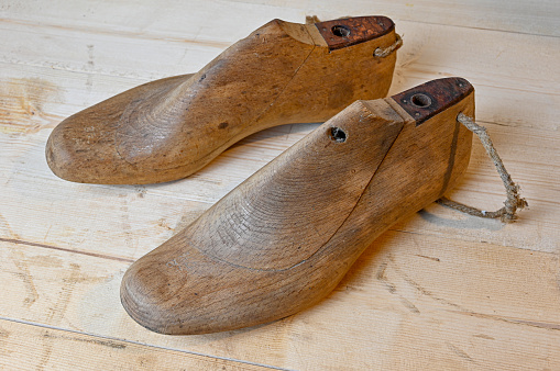 vintage wooden shoe lasts standing on wooden bench in Sweden