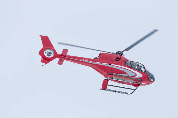istock Red rescue helicopter fly in snowy mountains 1285953419