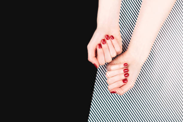 istock Woman hands with perfect classic manicure with red polish. 1285953636
