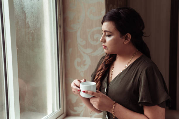 istock Thoughtful woman thinking and looking away while drinking hot tea or coffee 1285954187