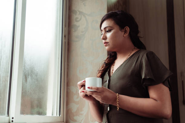 istock Thoughtful woman thinking and looking away while drinking hot tea or coffee 1285954188
