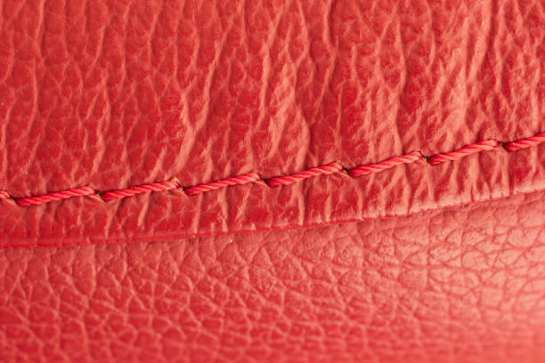 istock Red leather seams with stitching of a sofa macro close up shot 1285954732