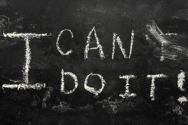 istock i can do it - chalk lettering on black background close up i can concept 1285955377