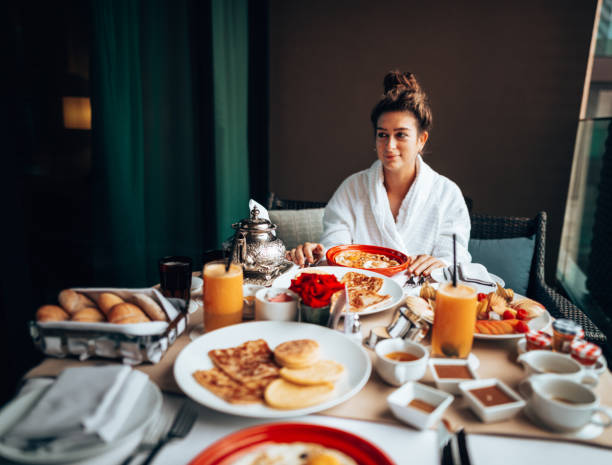 istock woman at the table for the buffet breakfast with fruit 1285956680