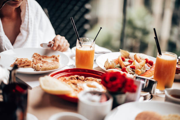 istock woman at the table for the buffet breakfast with fruit 1285956938