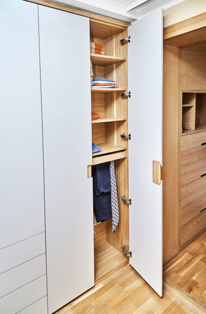 istock Modern wardrobe with finger pull design. Wooden wardrobe with light gray cabinet doors. Modern furniture 1285956986