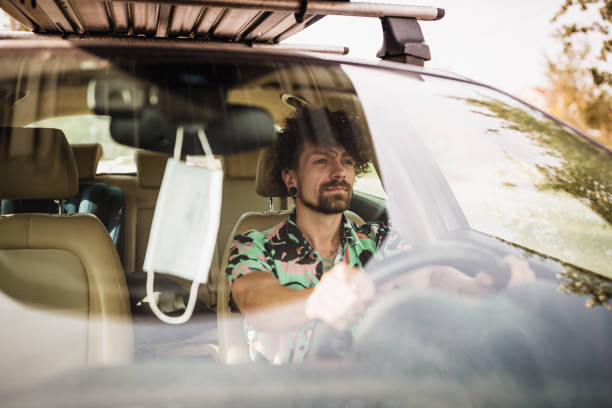 istock Young man driving a car 1285957060