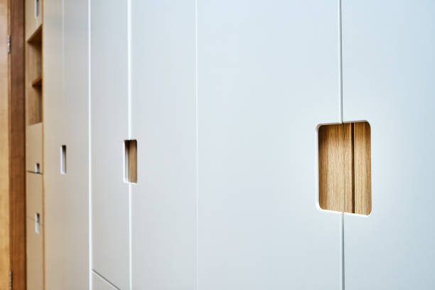 istock Modern wardrobe with finger pull design. Wooden wardrobe with light gray cabinet doors. Modern furniture 1285957940