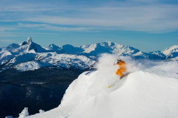 The pleasure of skiing fresh powder Male skiing fresh powder in the mountains. Top ski destinations in the world. Best ski resorts in North America. whistler skiing stock pictures, royalty-free photos & images
