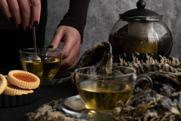 istock Woman hands pouring tea from  a teapot 1285959757
