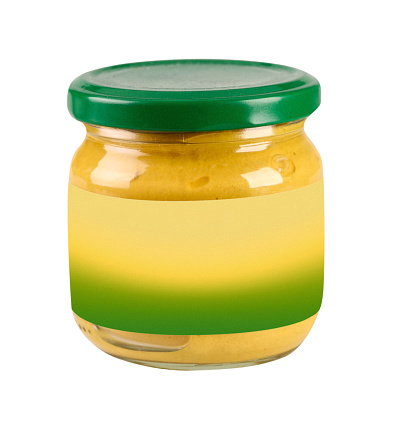 Glass preserve jar of mustard with blank label on a white background, clipping path included