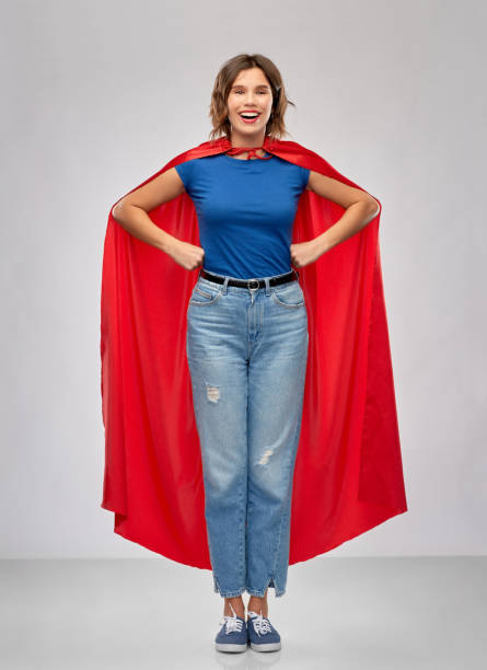 istock happy woman in red superhero cape 1285960346