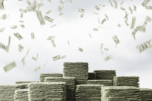 Dollar rain and stacks of dollars over cloudy sky background. Concept of investment, success and finances. 3d rendering