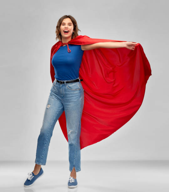 istock happy woman in red superhero cape 1285960490