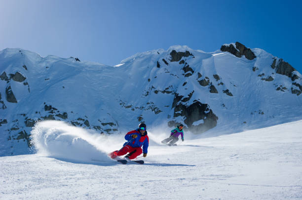 istock Couple skiing in the mountains 1285961330