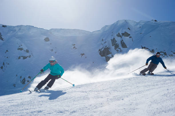 istock Couple skiing in the mountains 1285961351
