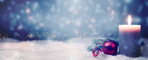 istock beautiful christmas background with candle light on blurred snowy winter landscape, abstract advent season concept with advertising space 1285961431