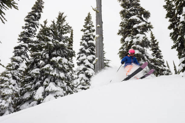 istock Woman skiing fresh powder on a ski vacation 1285962058