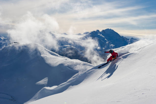 Woman skiing fresh powder on a ski vacation stock photo