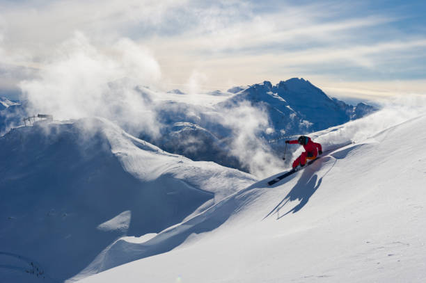 Woman skiing fresh powder on a ski vacation Female skiing fresh powder in the mountains. Winter ski vacation escaping in the mountains. Skiing at Whistler Mountain. whistler skiing stock pictures, royalty-free photos & images