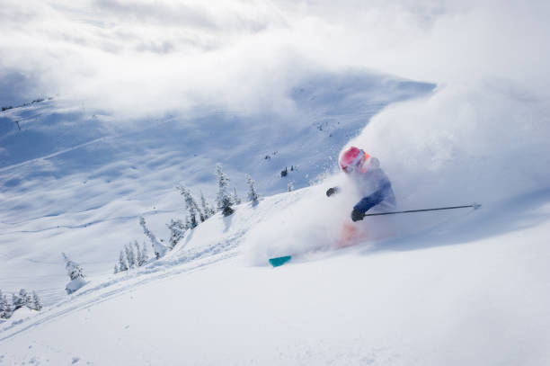 istock Woman skiing fresh powder on a ski vacation 1285962369