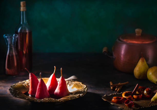 Poached pears in red wine recipe with cinnamon and citrus peel with ingredients moody low key dark