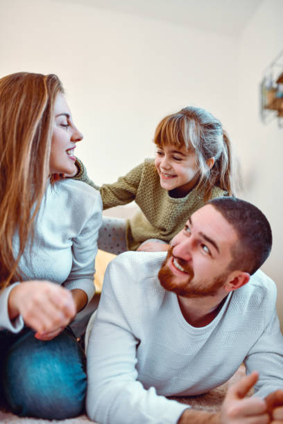istock Happy Family With Child Lying Down On Floor 1285963855