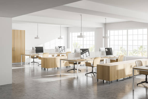 istock Modern white open space office corner with wooden tables 1285964231