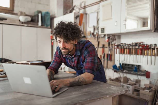 istock Manual worker repairing acoustic guitar at his workshop 1285965506