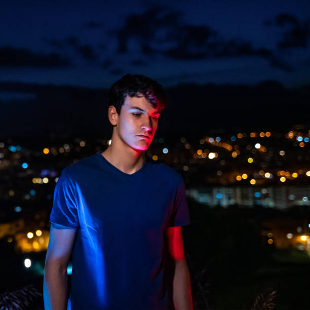 istock Young man with city lights at background 1285965700