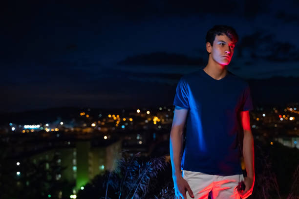 istock Young man with city lights at background 1285965701