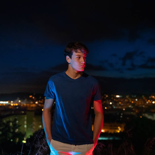istock Young man with city lights at background 1285965702