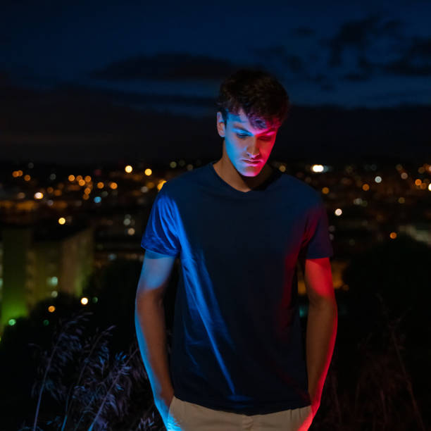 istock Young man with city lights at background 1285965705