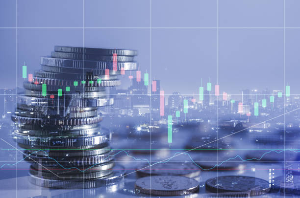 istock double exposure of city with row of coin stack with growth stock chart and graph progress report for business investment finance banking and money saving concept. 1285965894