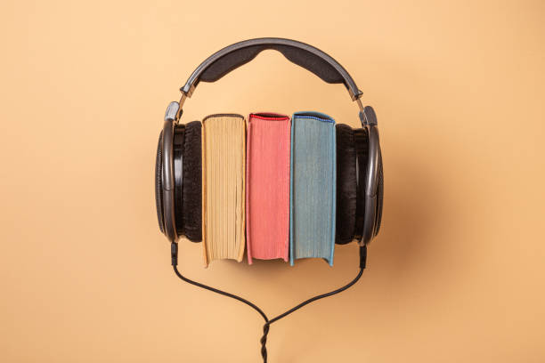audiobooks concept headphones on books, audiobooks concept audio book stock pictures, royalty-free photos & images