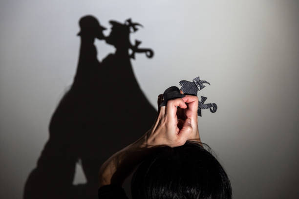 istock play shadow projected against a white background. two little people 1285966278