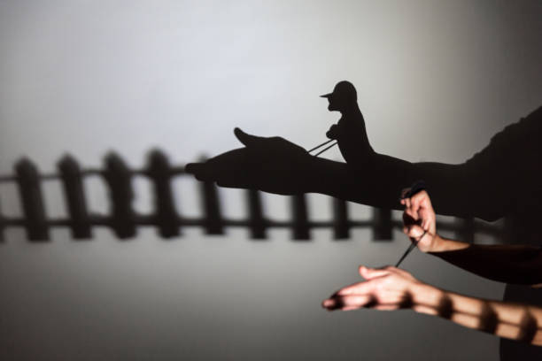 istock play shadow projected against a white background. horse, rider. 1285966306