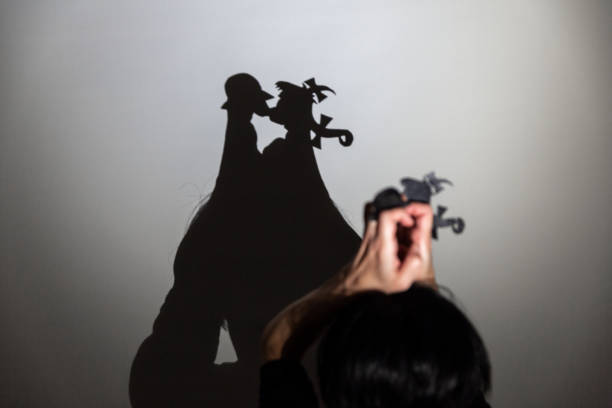 istock play shadow projected against a white background. two little people 1285966458