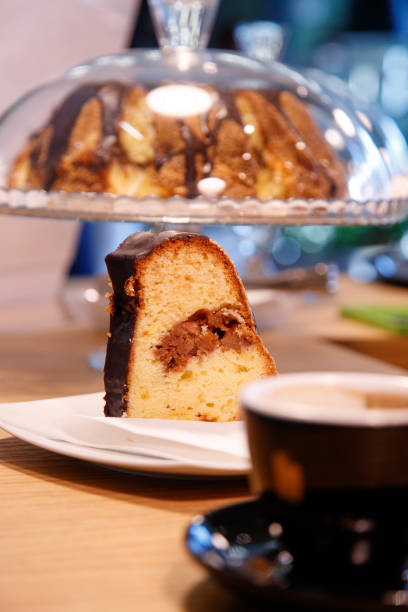istock Piece of marble cake on a plate on the counter 1285966480