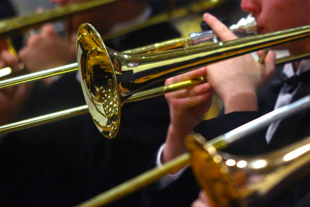 Student Musicians Play Trombones Student musicians play trombones in a close-up image. rehearsal photos stock pictures, royalty-free photos & images