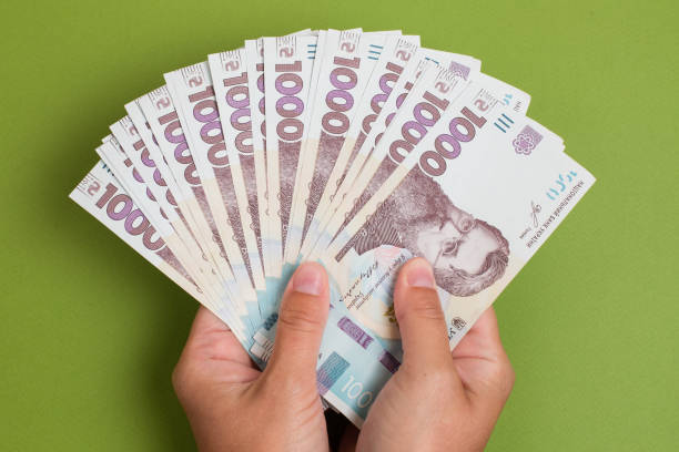 istock Stack of ukrainian hryvnia banknotes in hands 1000 uah 1285967704