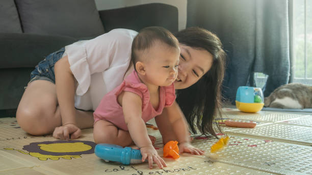 istock Mother and son playing on the floor 1285970390