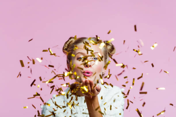 istock Beautiful teenege girl blowing confetti 1285971414
