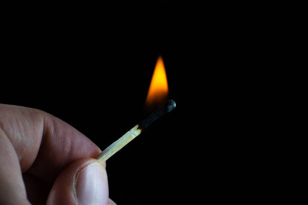istock Burning match in a man's hand. New idea concept. 1285971987