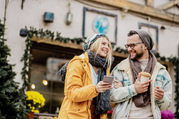 istock Young couple outdoors during winter using smart phone 1285972169