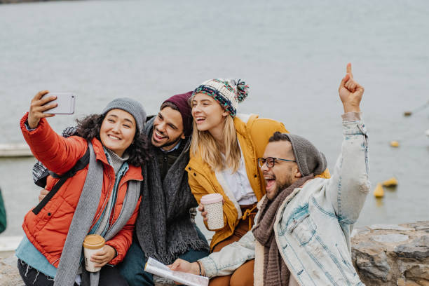 istock Group of friends outdoors having fun and taking selfie 1285973217