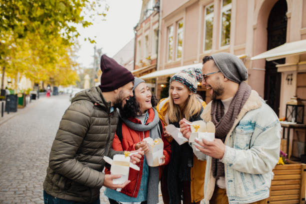istock Friends outdoors eating fast food and having fun 1285973324