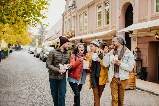 istock Friends outdoors eating fast food and having fun 1285973459