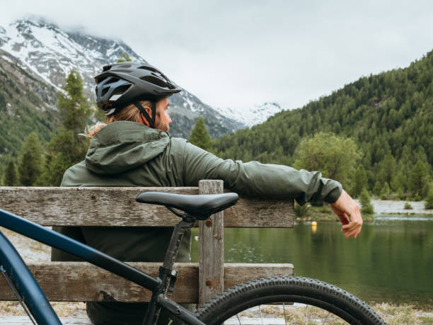 istock Mountain biker relaxes by lakeshore 1285973508